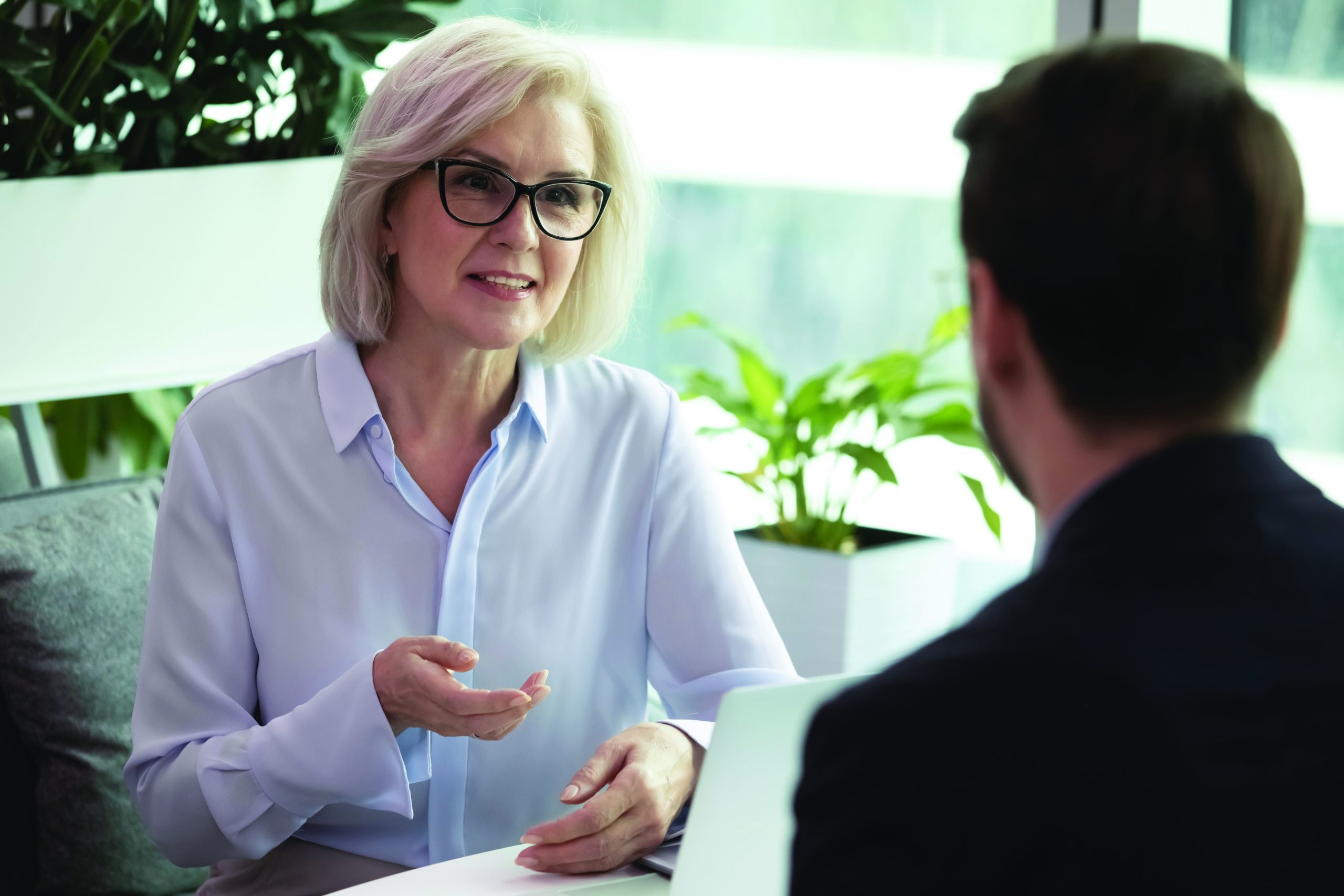 Middle-aged,Caucasian,Businesswoman,Talk,With,Male,Colleague,Coworker,At,Meeting