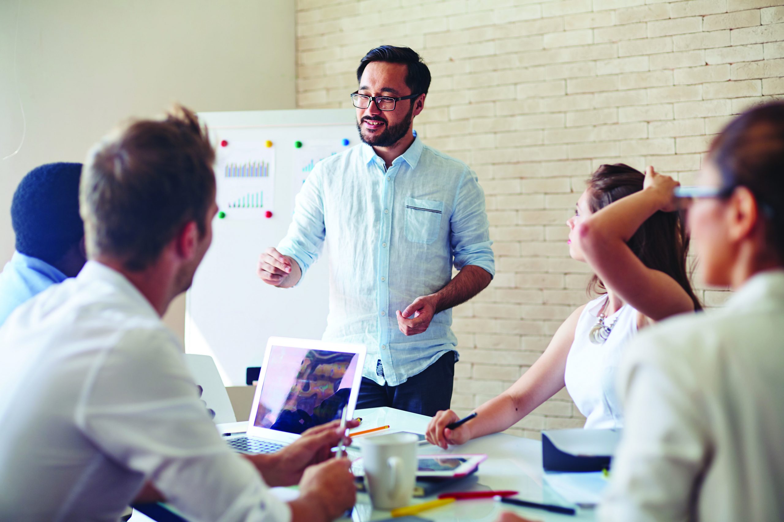 Modern,Businessman,Explaining,His,Ideas,To,Colleagues,At,Seminar